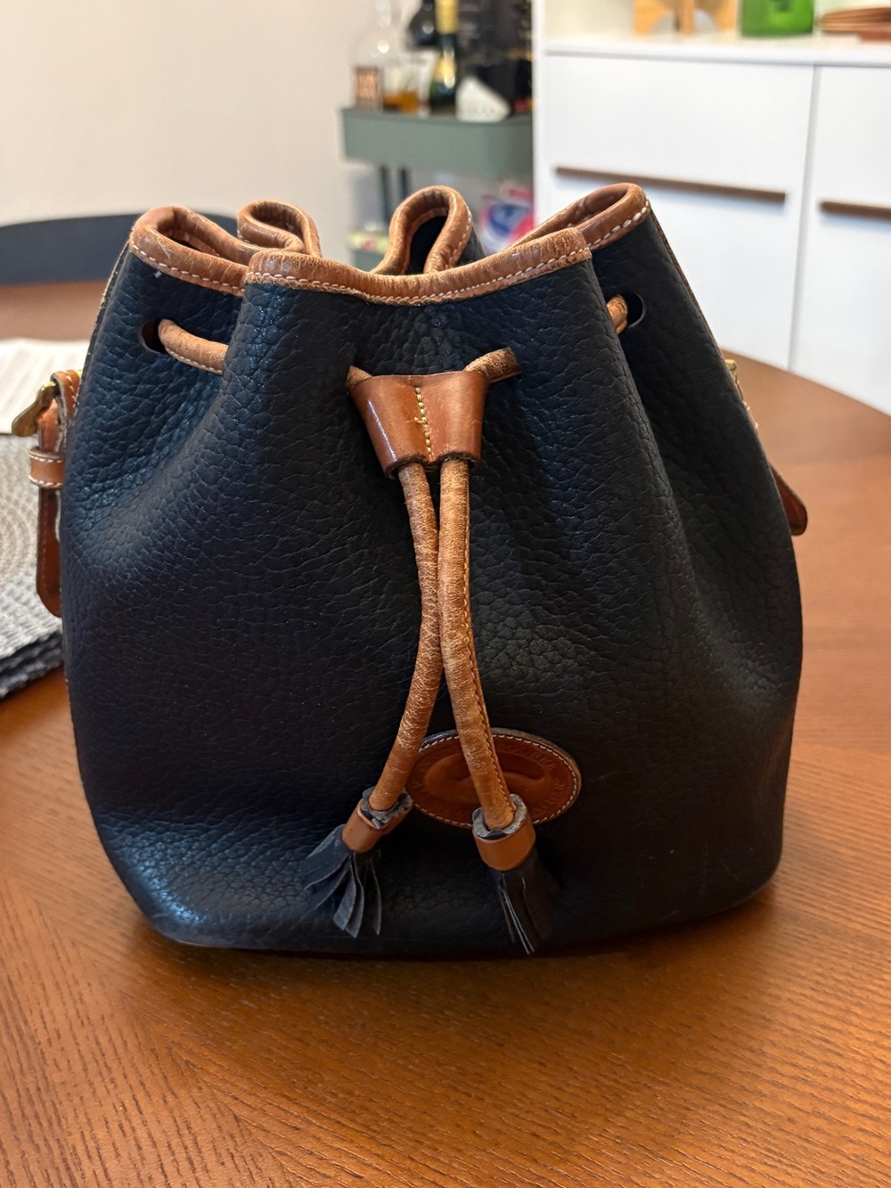 Dooney & Bourke Black Pebbled Leather Drawstring Bucket Bag with Brown Trim